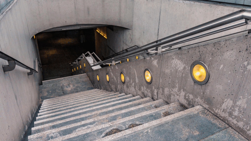 Poorly lit concrete stairs with surface debris and missing traction, representing a common cause of slip and fall injuries in Mississippi